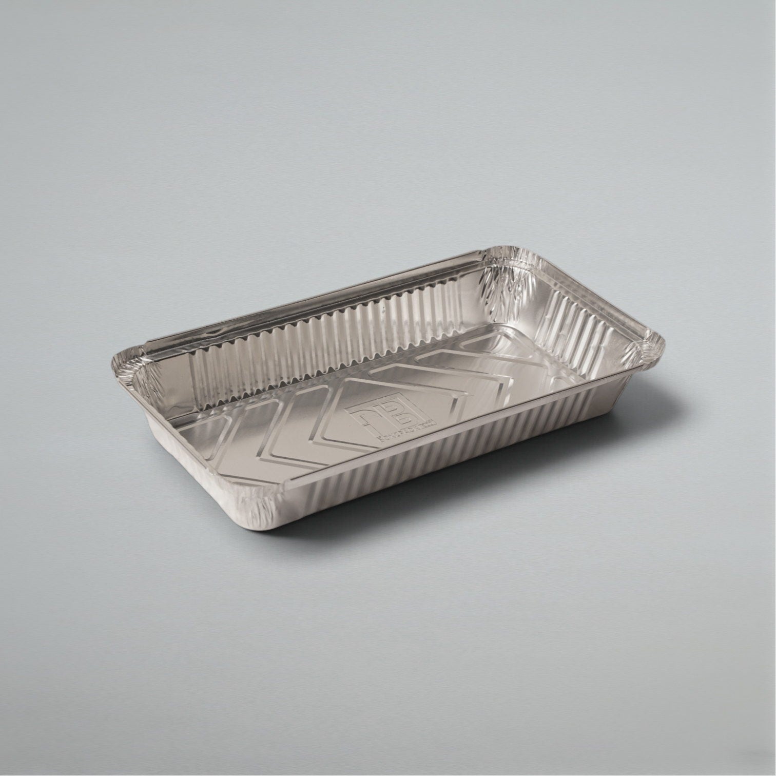 A rectangular aluminum foil tray with a crimped rim and a reflective metallic surface, photographed on a clean light gray background.