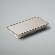 A rectangular disposable aluminum foil tray with a matching lid, shown on a neutral light gray background.