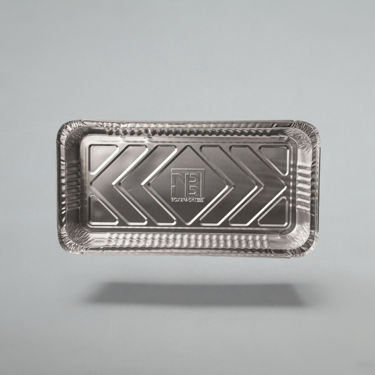 A rectangular silver aluminum foil tray with a textured, crimped edge and a raised chevron pattern in the center, shown floating against a neutral gray background.
