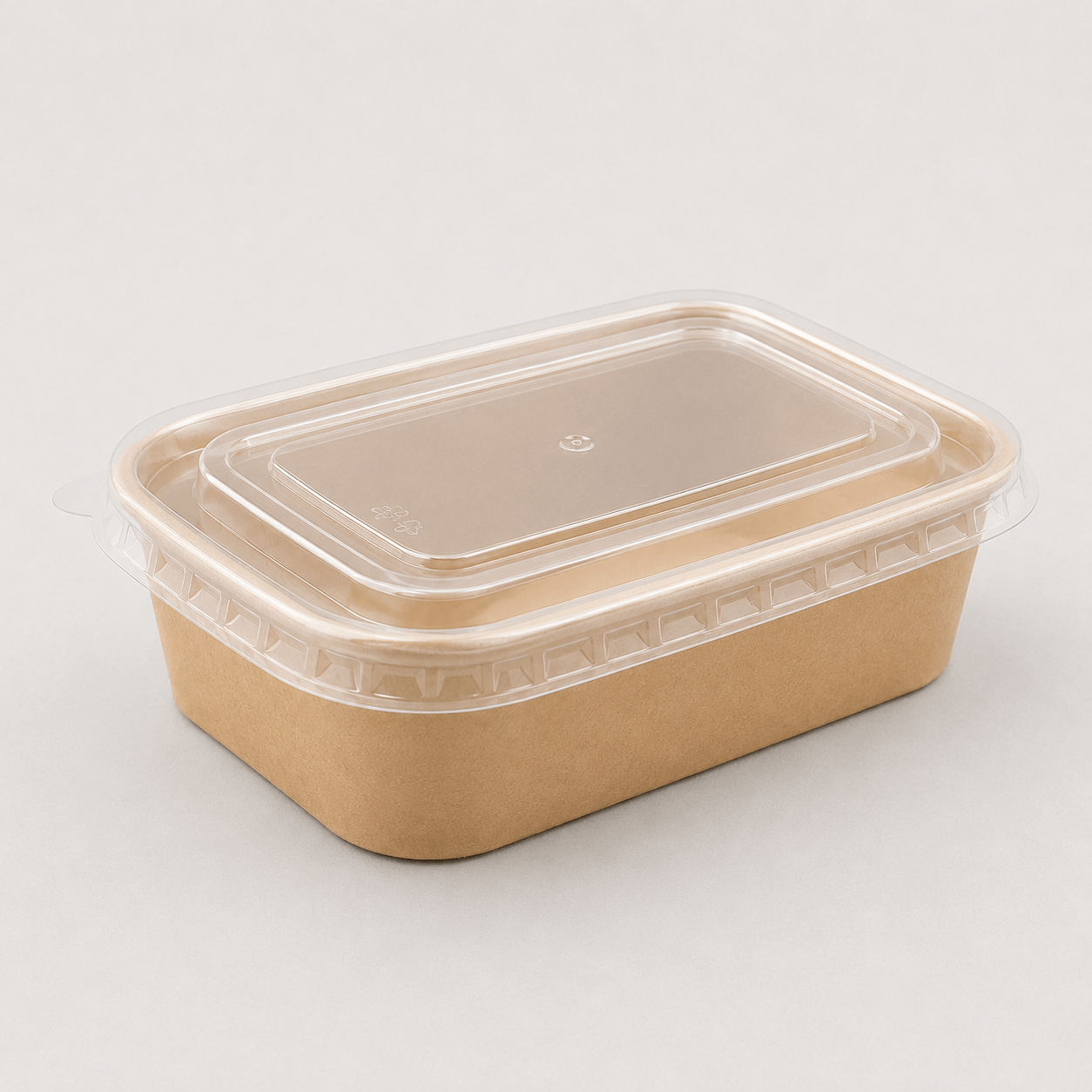 A rectangular brown kraft paper food container with a clear plastic lid, photographed on a plain beige background.