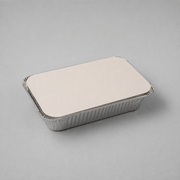 A rectangular silver aluminum foil tray with a flat, plain lid, photographed on a neutral light gray background.