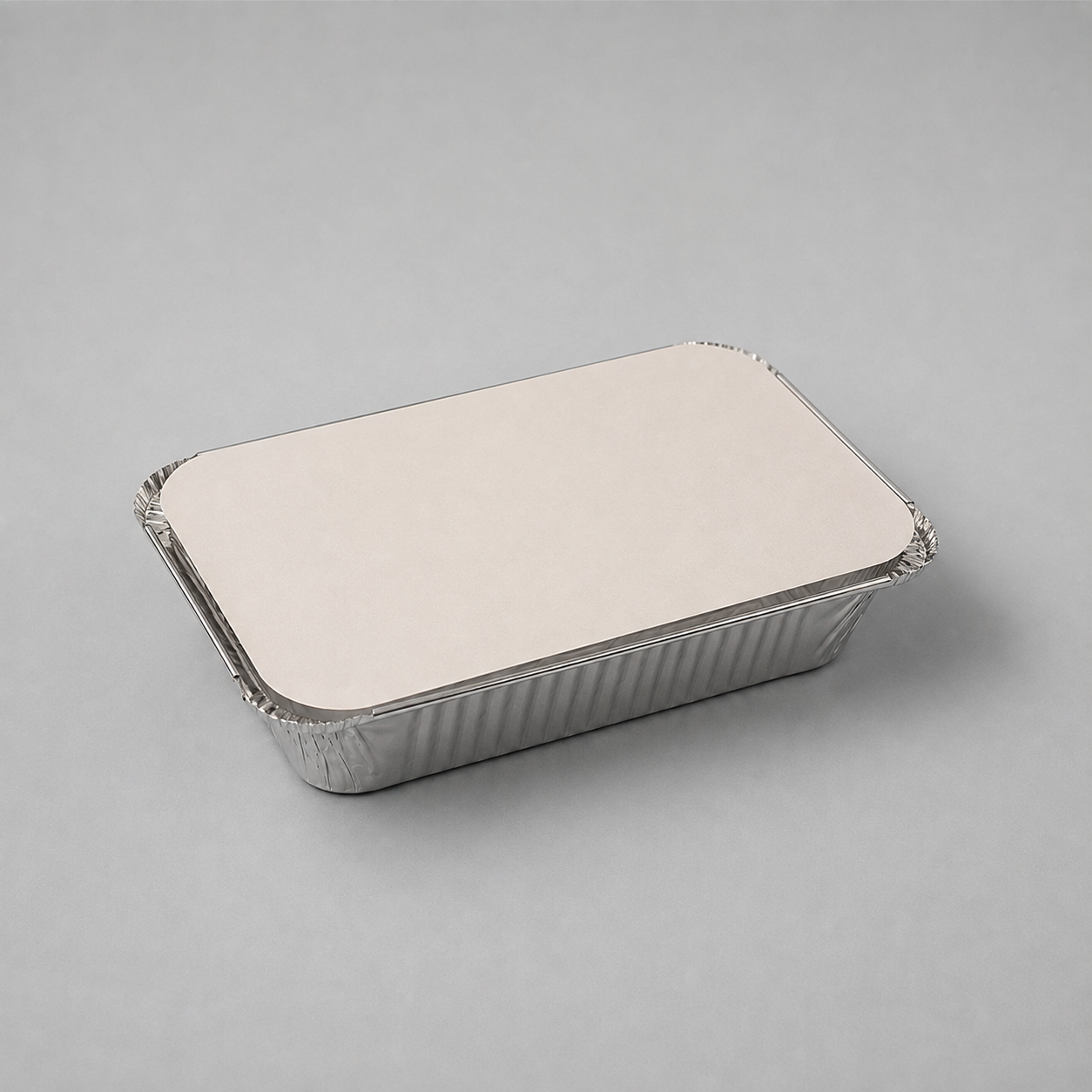 A rectangular silver aluminum foil tray with a flat, plain lid, photographed on a neutral light gray background.