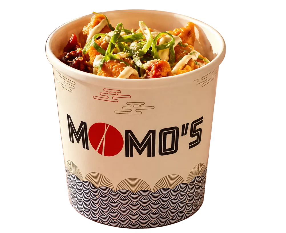 A paper cup of spicy food with green onions and red chili oil, shown on a white background with a pair of chopsticks in the lower left corner. The cup is branded with 'MOMO'S'.