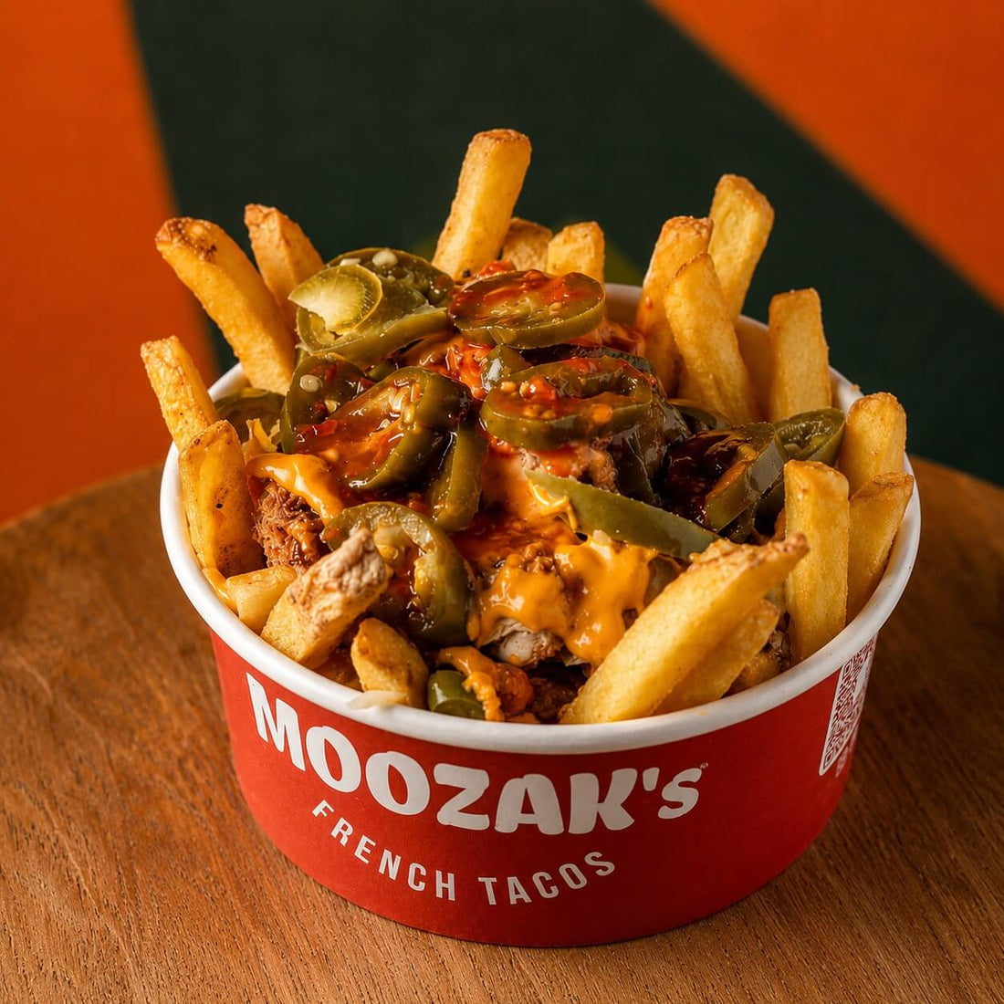 Moozak’s French Tacos branded takeaway food bowl filled with loaded fries, chicken, jalapeños, cheese and sauce.