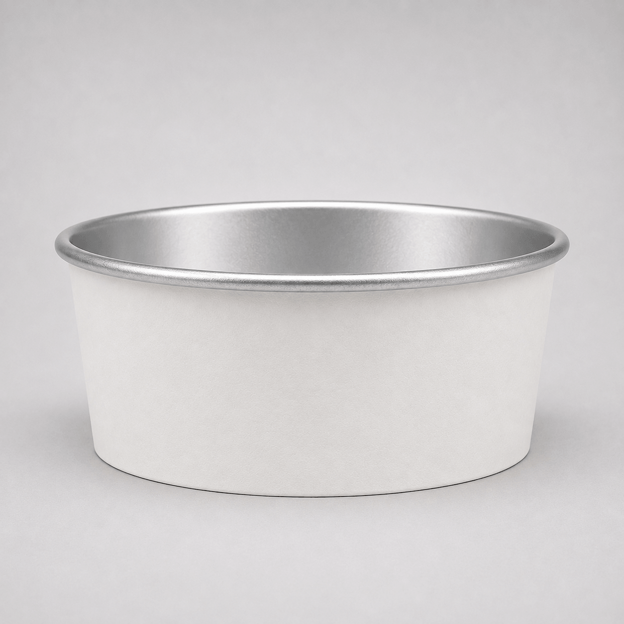 A round metal pet bowl with a white exterior and a silver interior, shown on a neutral gray background.